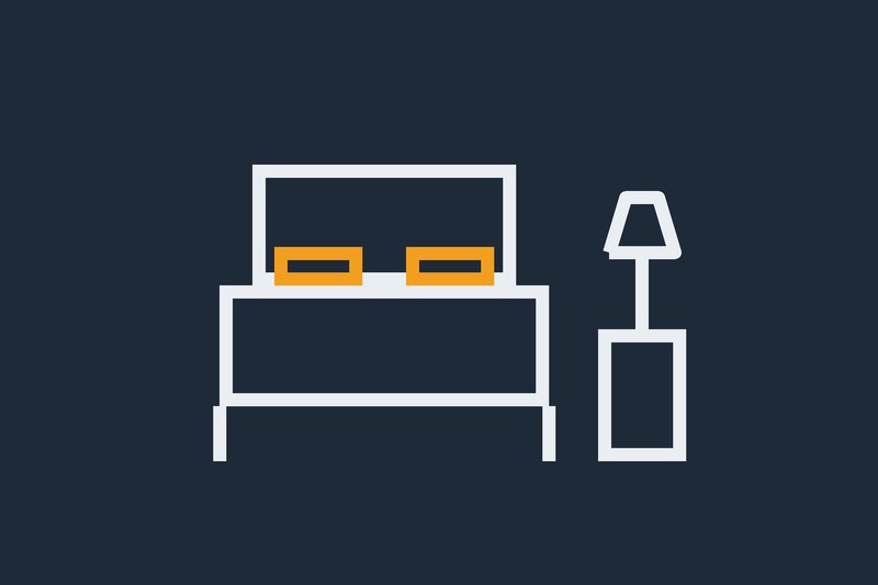 Simple graphic of a hotel bed and bedside lamp