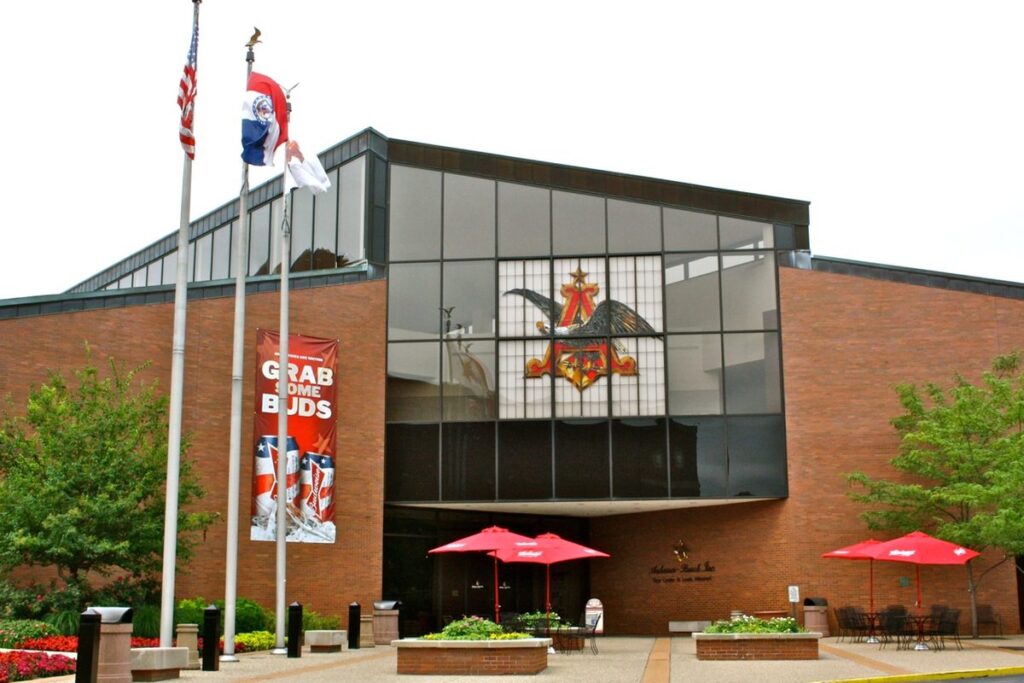 Tour center entrance at the Anheuser-Busch Brewery in St. Louis, Missouri, with flags and red umbrellas