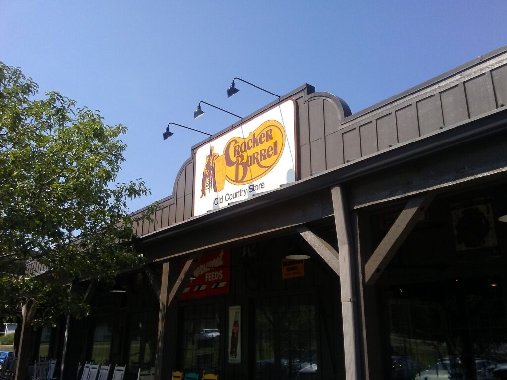 Front entrance of a Cracker Barrel Old Country Store restaurant in Cleveland, Tennessee, with its sign above the porch